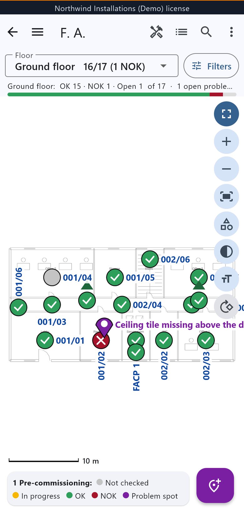 A floor on a phone: green checks for devices that passed, a red cross for one that failed